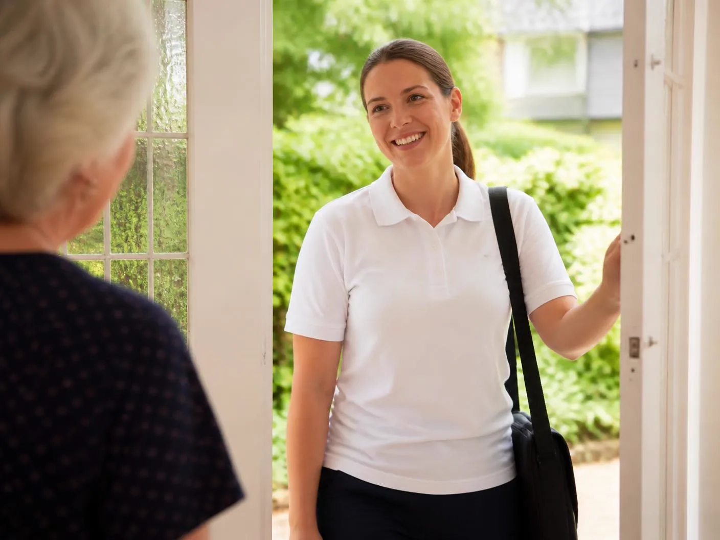 A caregiver arriving at a client's front door